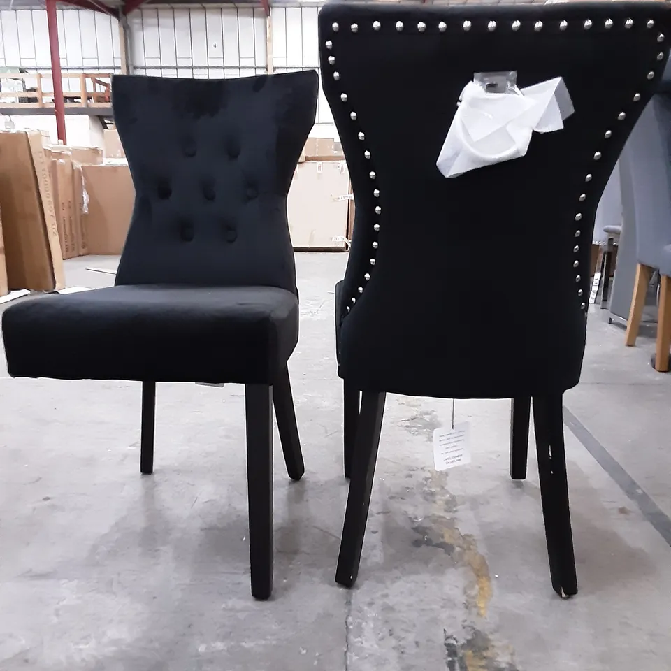 SET OF 4 UPHOLSTERED BLACK VELVET DINING CHAIRS WITH A STUDDED  BORDER , 1 CHAIR HAS 1 BROKEN LEG 