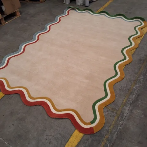 BEIGE RUG WITH MULTICOLOURED WAVY BORDER APPROXIMATELY 200×290CM