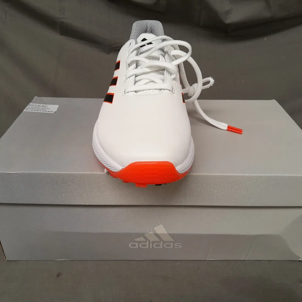 BOXED PAIR OF ADIDAS ZG23 GOLF SHOES IN WHITE/BLACK/ORANGE UK SIZE 7