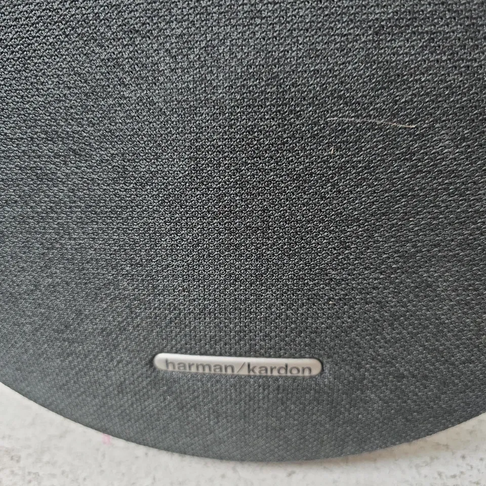 HARMAN/KARDON PORTABLE BLUETOOTH SPEAKER – BLACK, ROUND FABRIC SPEAKER