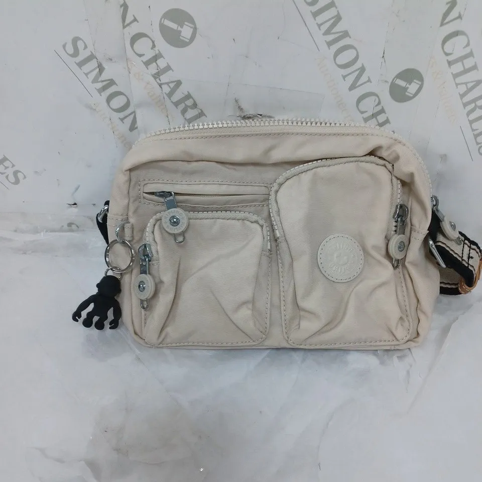 KIPLING LIVE LIGHT SMALL SHOULDER BAG. MULTIPLE COMPARTMENTS. COMES WITH A GORILLA KEYRING. CREAM AND BLACK