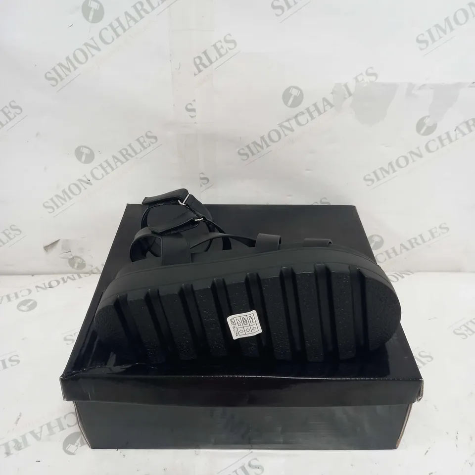 BOXED PAIR OF KOI FOOTWEAR CRIX CHUNKY BLATFORM SANDALS IN BLACK PU - SIZE 6