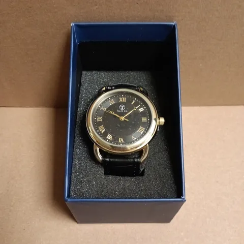 BOXED TALIS CO. WRISTWATCH GOLD-TONE, BLACK DIAL WITH ROMAN NUMERALS, BLACK LEATHER STRAP