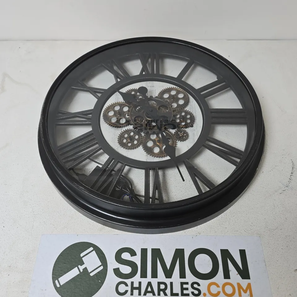 ROUND BLACK METAL WALL CLOCK WITH EXPOSED GEARWORK AND ROMAN NUMERALS