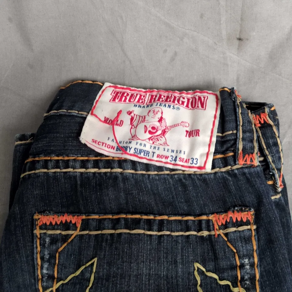 TRUE RELIGION JEANS – WORLD TOUR PATCH DENIM JEANS - SIZE UNSPECIFIED