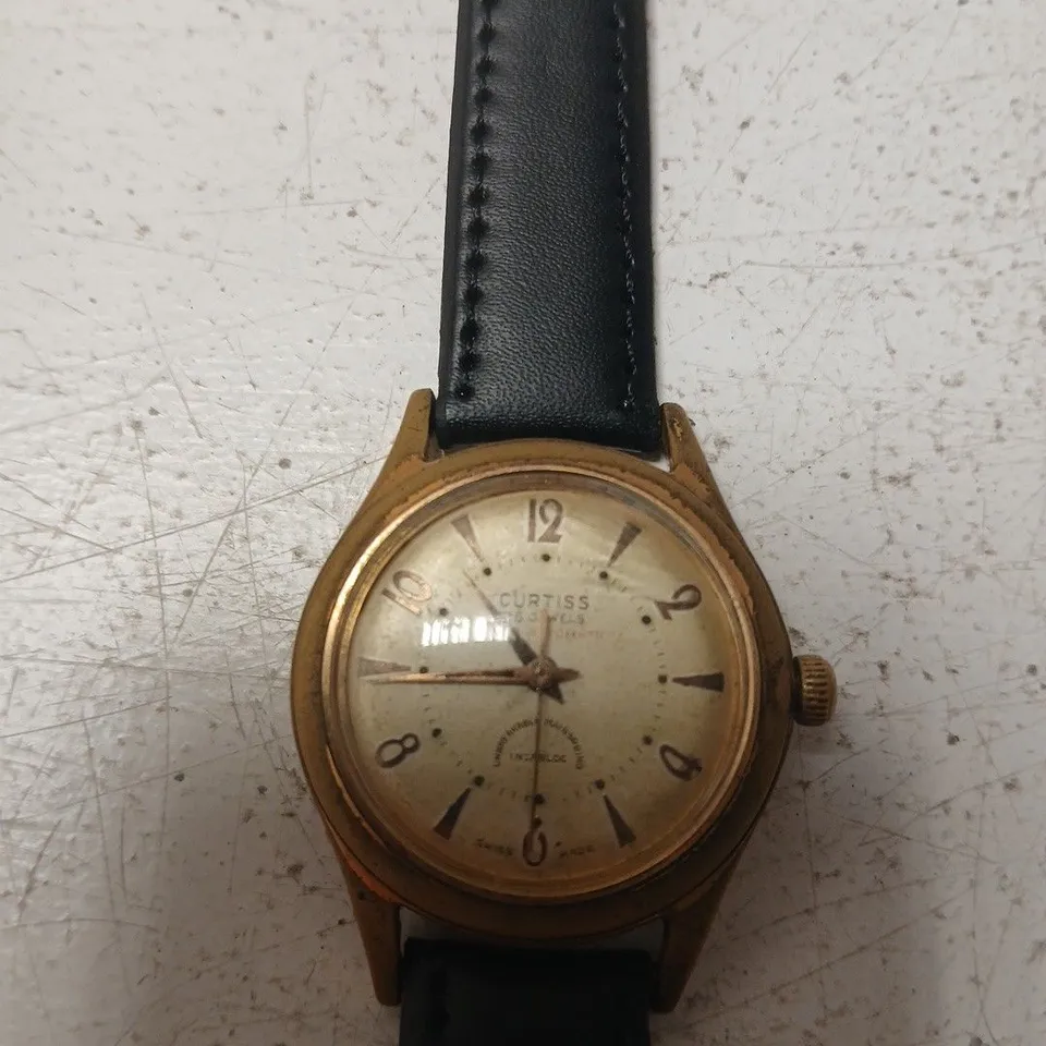 CURTISS AUTOMATIC WRISTWATCH – VINTAGE GOLD TONE CASE, BLACK LEATHER STRAP
