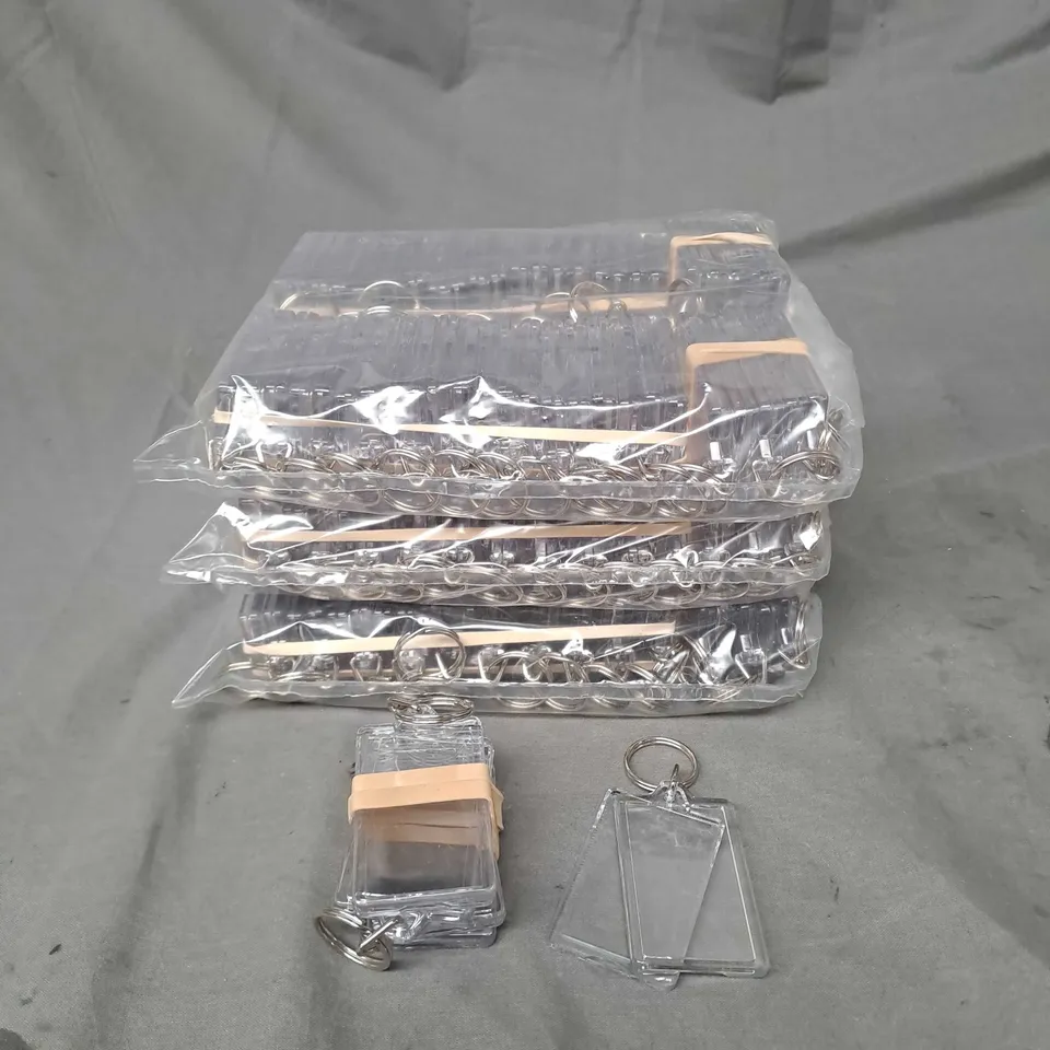 APPROXIMATELY 50 CLEAR PLASTIC PHOTO KEYRINGS