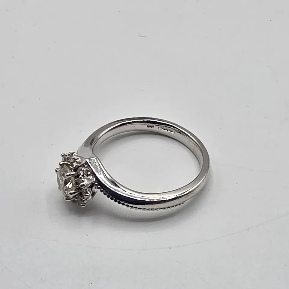 18CT WHITE GOLD RING SET WITH A NATURAL DIAMOND TO NATURAL DIAMOND HALO