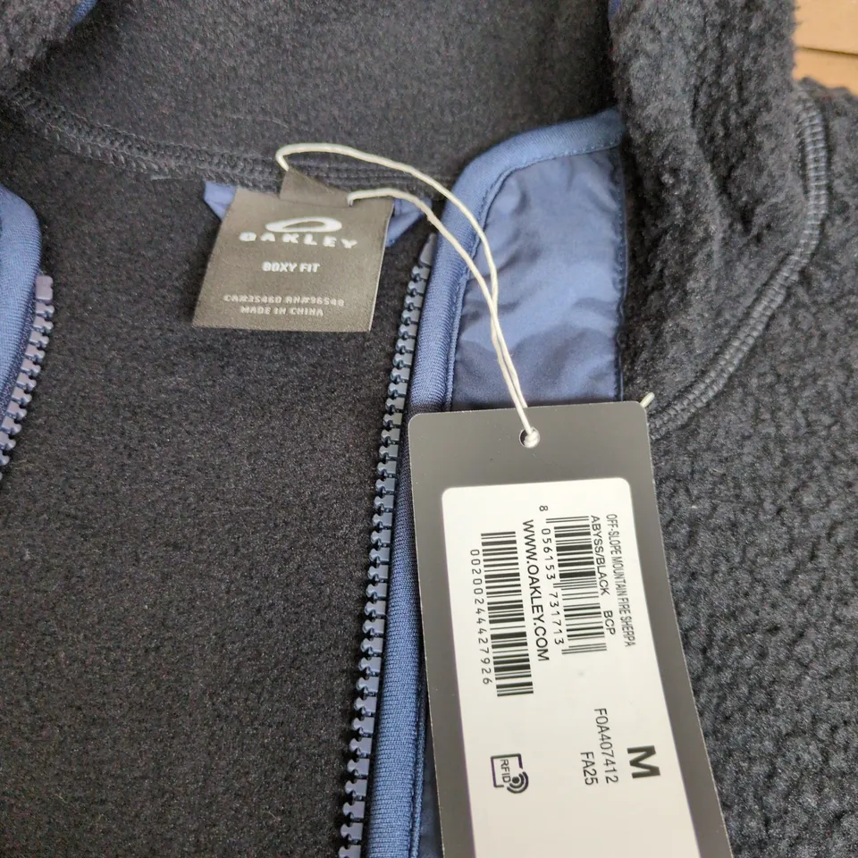 OAKLEY FLEECE JACKET - BLACK WITH BLUE NYLON CHEST PANEL SIZE M