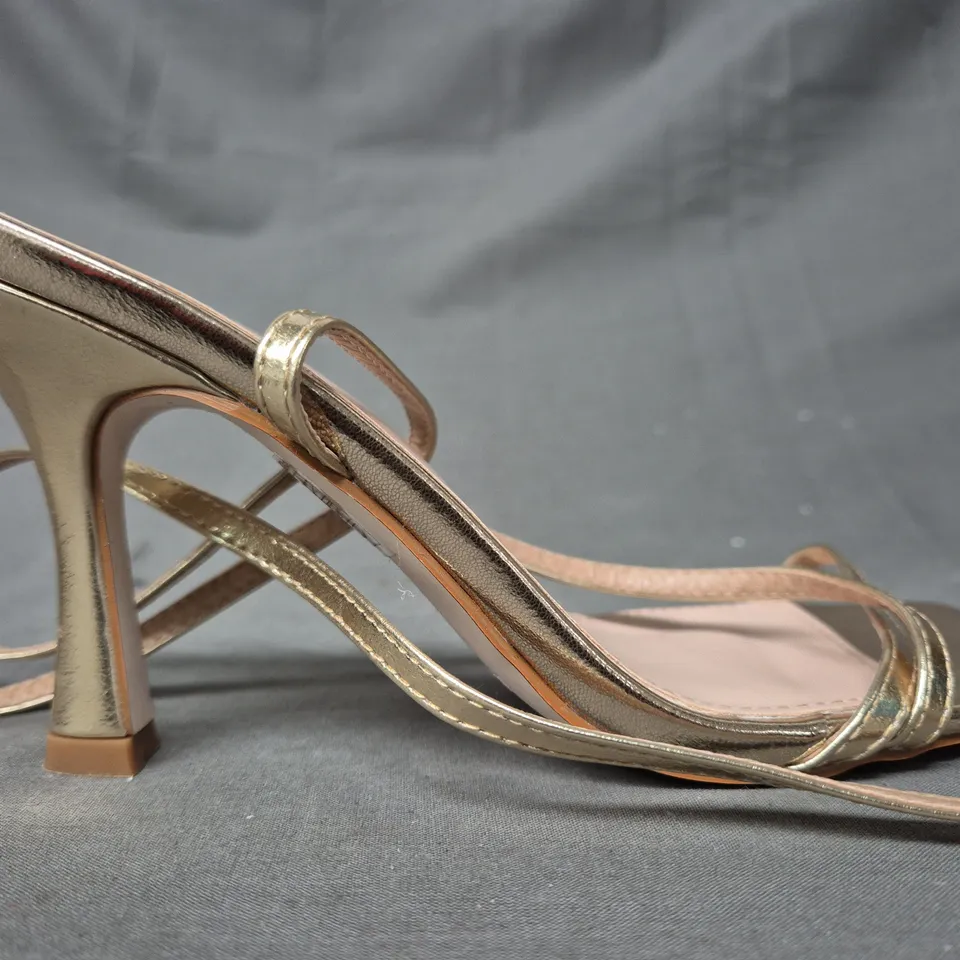 BOXED PAIR OF RAID OPEN TOE STRAPPY HEELED SANDALS IN METALLIC GOLD SIZE 4