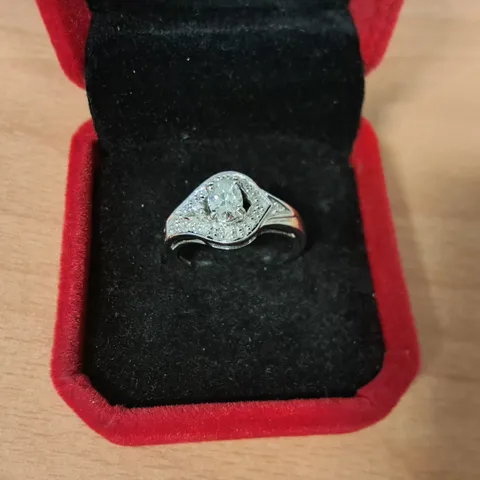 18CT WHITE GOLD RING SET WITH A NATURAL OVAL CUT DIAMOND TO NATURAL DIAMOND HALO