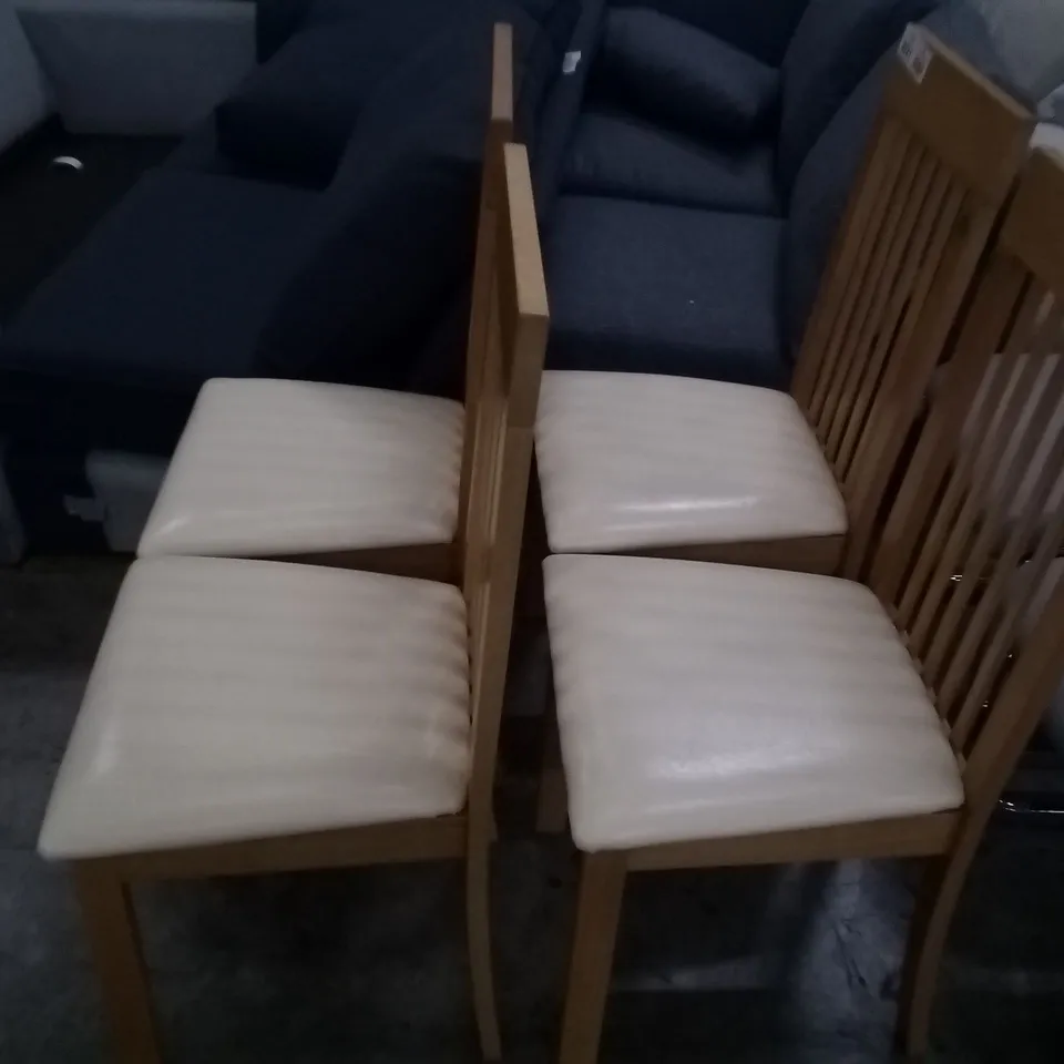 APPROXIMATELY 4 OAK EFFECT SLATTED BACK DINING CHAIRS WITH CREAM FAUX LEATHER SEAT PADS 