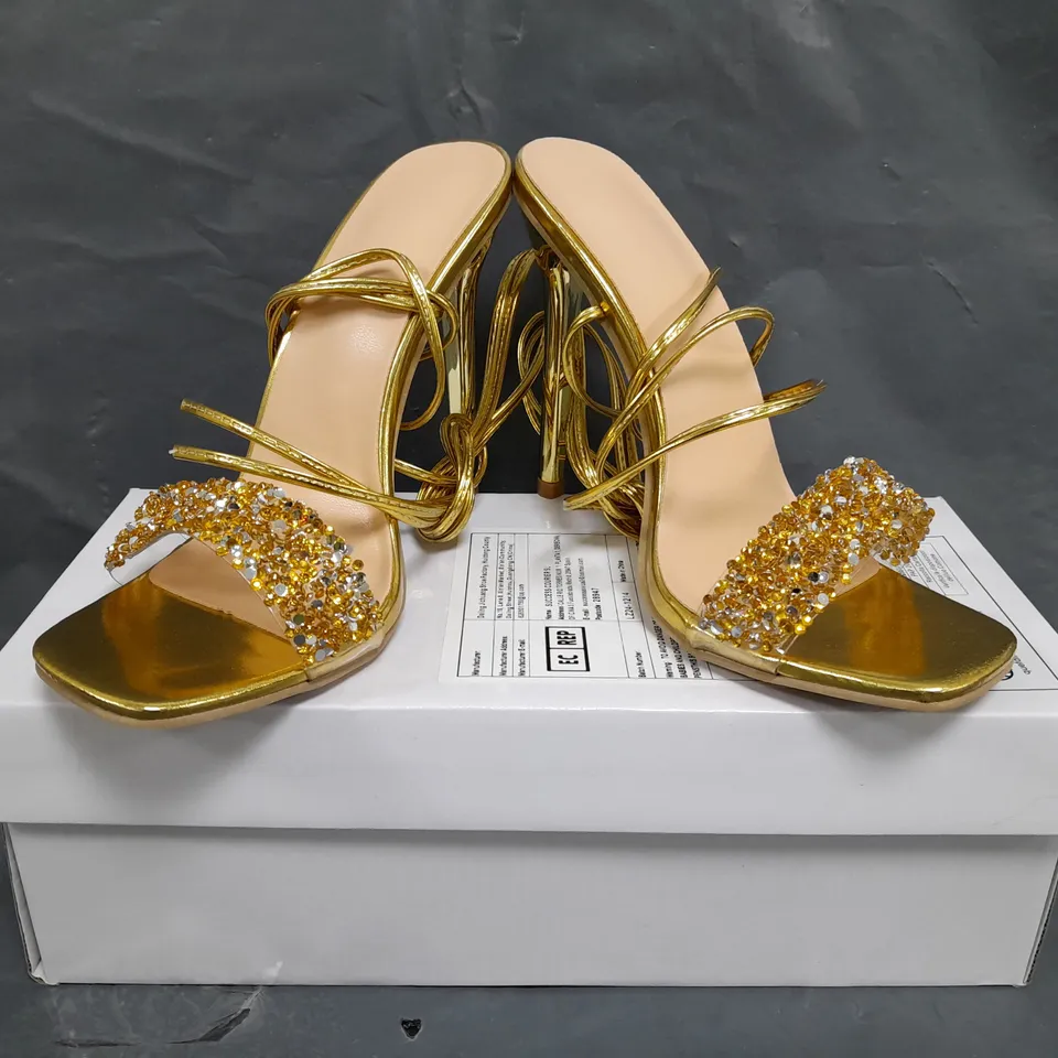 BOXED PAIR OF UNBRANDED HIGH HEELED STRAPPY SANDALS IN METALLIC GOLD W. JEWEL EFFECT SIZE EU 37