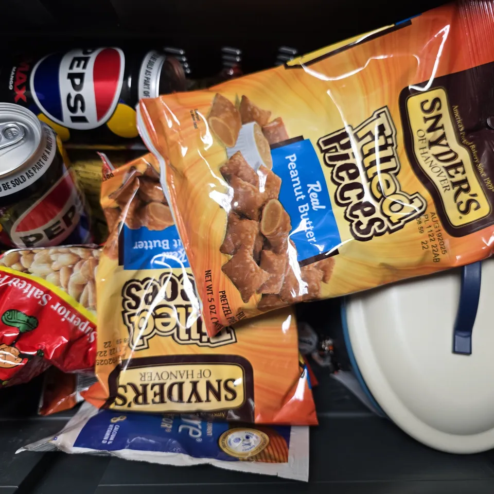 APPROXIMATELY 10 ASSORTED FOOD & DRINK ITEMS TO INCLUDE - PEPSI MAX MANGO , SNYDERS FILLED PIECES REAL PEANUT BUTTER ETC