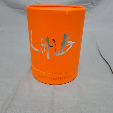 Teeth Whitening Serum – Orange cylindrical packaging with applicator and clear jar