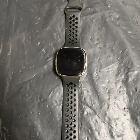 FITBIT SMARTWATCH WITH BLACK PERFORATED STRAP – SQUARE-FACE