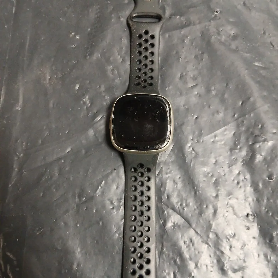 FITBIT SMARTWATCH WITH BLACK PERFORATED STRAP – SQUARE-FACE