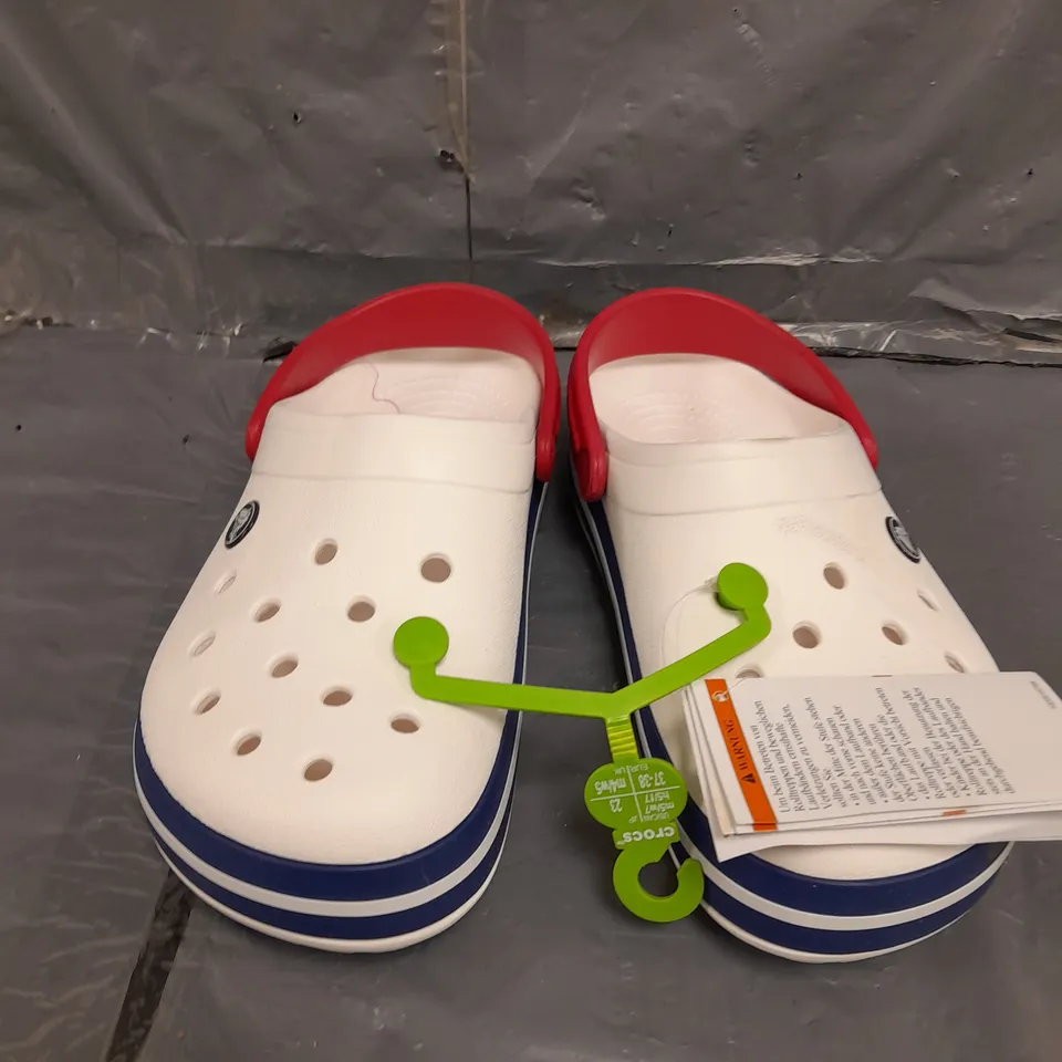 PAIR OF COCBAND CROCS IN WHITE SIZE 4