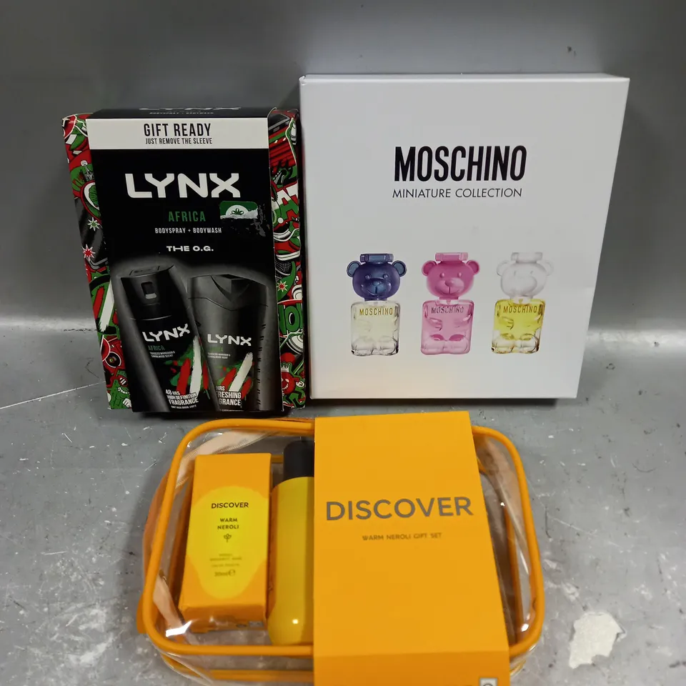 LOT OF 3 ASSORTED COSMETIC BOXSETS TO INCLUDE - LYNX AFRICA BODY COLLECTION - MOSCHINO MINIATURE COLLECTION - DISCOVER WARM NEROLI GIFT SET