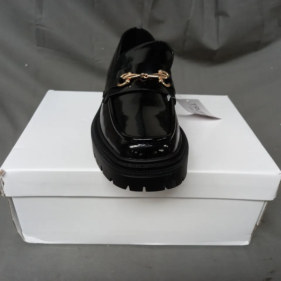 BOXED PAIR OF TRUFFLE COLLECTION LOAFERS IN GLOSSY BLACK W. GOLD EFFECT DETAIL SIZE 5