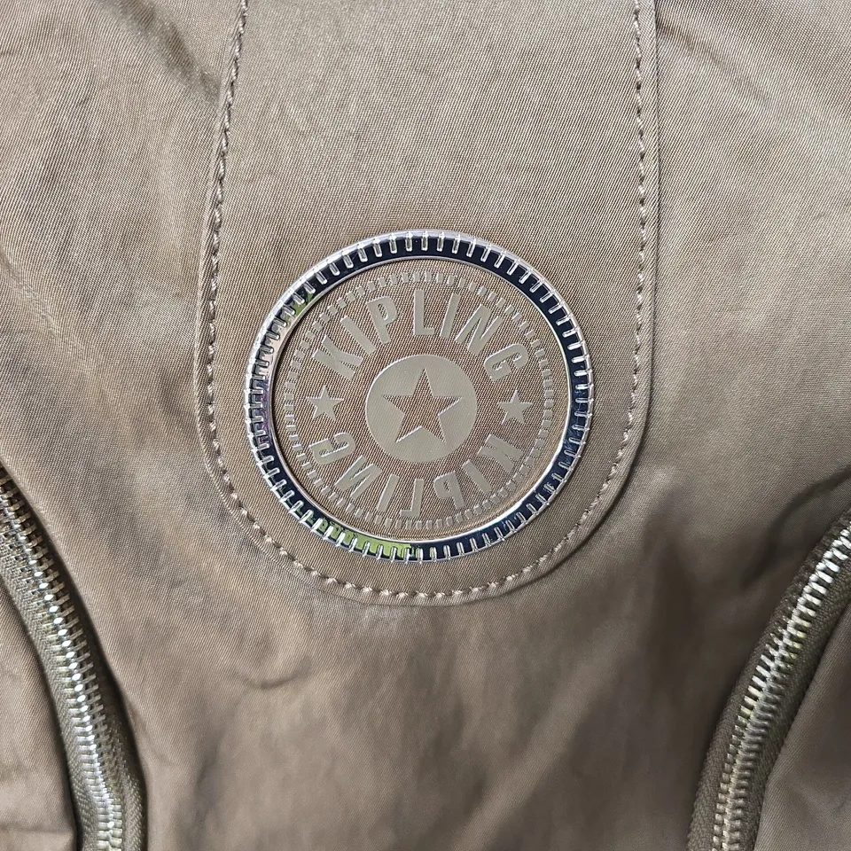 KIPLING CROSSBODY BAG – TAN NYLON WITH SIGNATURE ROUND LOGO DISC