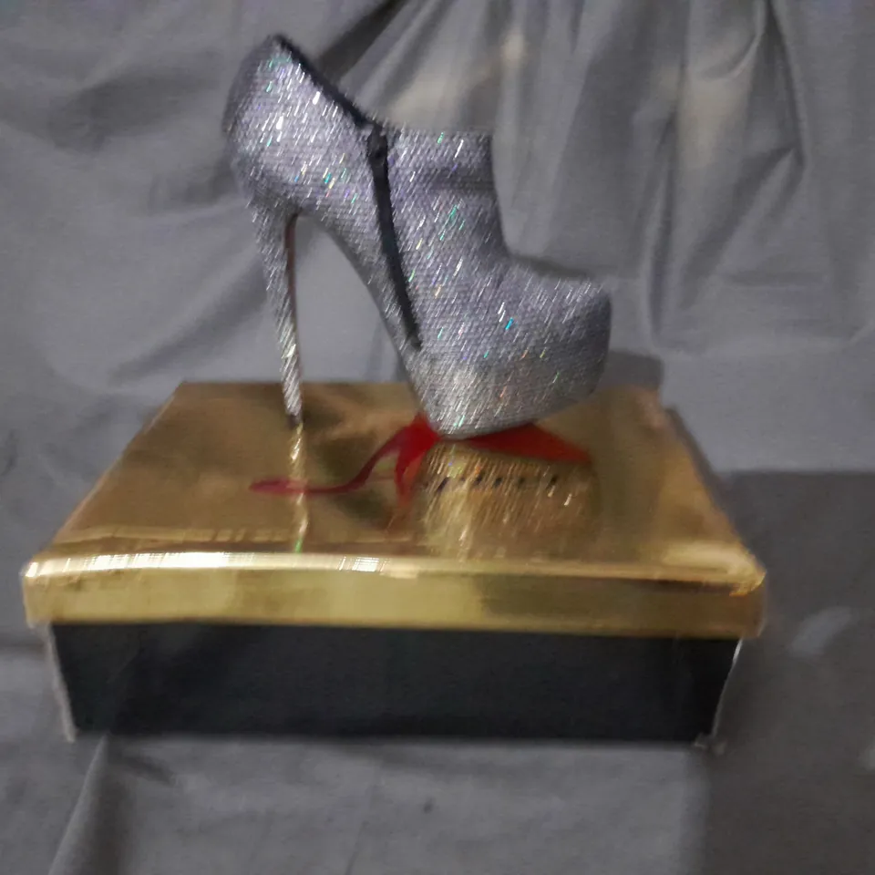 APPROXIMATELY 10 BOXED PAIRS OF SILVER HIGH HEEL BOOTS VARIOUS SIZES