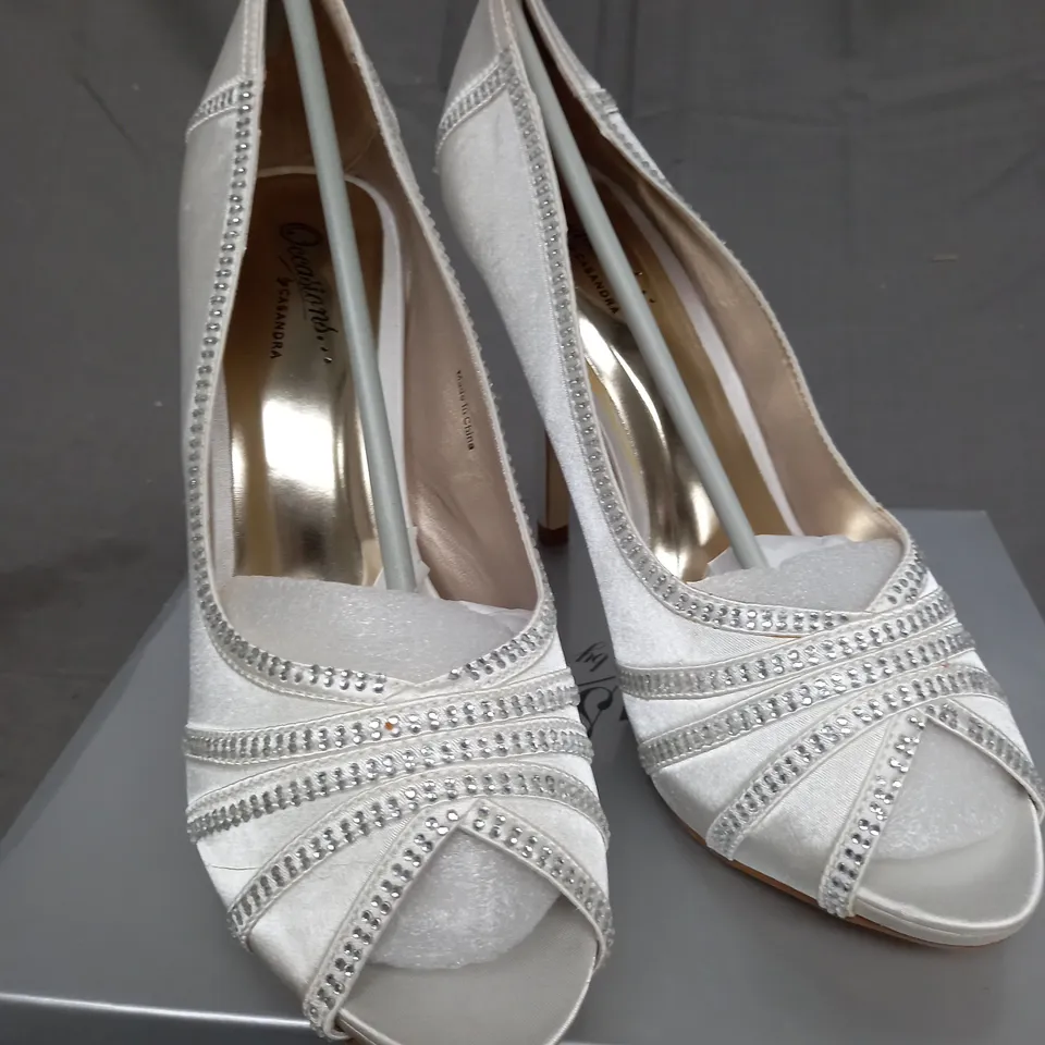 BOX OF 14 PAIRS OF IVORY SATIN HIGH HEELED SHOES 
