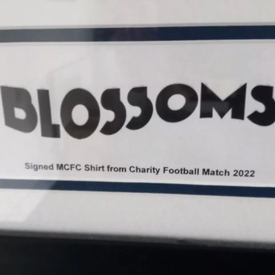 FRAMED AND MOUNTED MANCHESTER CITY SHIRT SIGNED BY STOCKPORT BASED BAND BLOSSOMS- ALL PROCEEDS WILL GO DIRECTLY TO CHARITY 