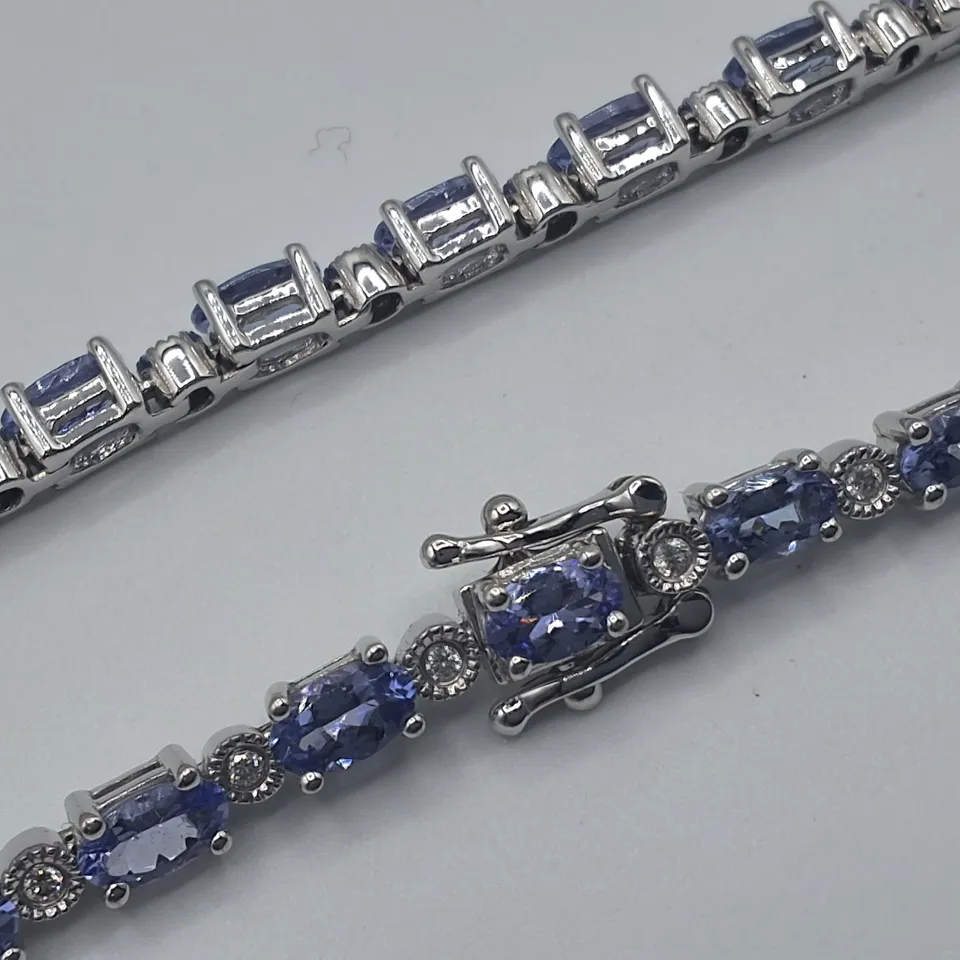 WHITE GOLD BRACELET SET WITH OVAL CUT TANZANITES AND NATURAL DIAMONDS WEIGHING +-6.11CT