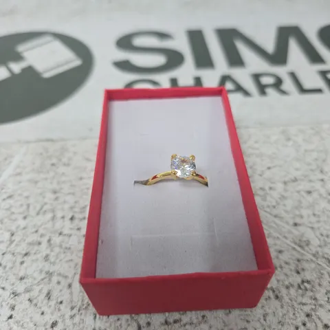 GOLD-TONE RING WITH CLEAR GEMSTONE IN RED PRESENTATION BOX
