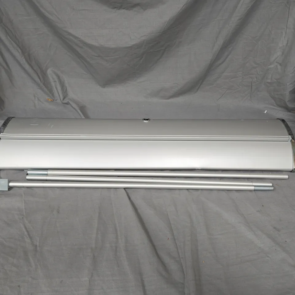 RETRACTABLE VINYL SIGN READING "RIDGE PHARMA" IN METAL CASE WITH LEGS. IN BLACK CARRY CASE