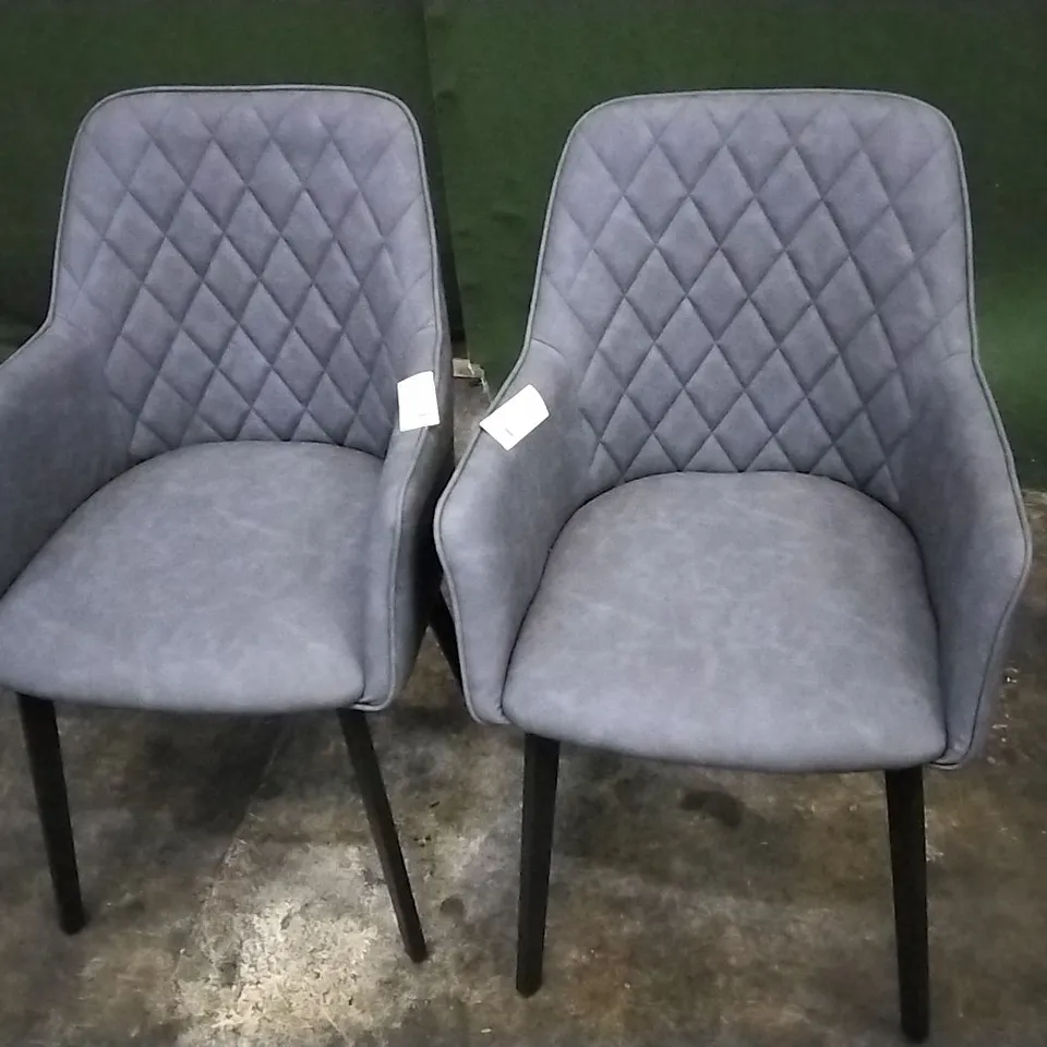 DESIGNER PAIR OF GREY LEATHER PILLOWED DINING CHAIRS WITH ARMREST AND BLACK LEGS