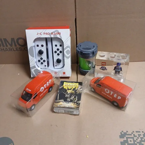TOTE OF APPROXIMATELY 20 ASSORTED TOYS/RELATED ITEMS TO INCLUDE J-C PAD, LEGO JURASSIC WORLD TOY, STRANGERS THINGS TOY, ADTRUCKS OTEP RED VAN MODELS ETC