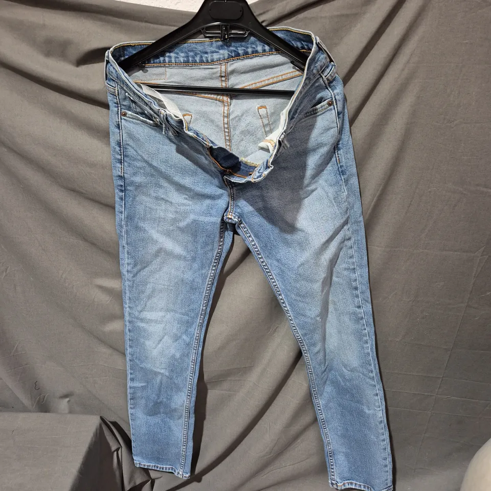 LEVI'S JEANS – BLUE DENIM WITH RED BACK PATCH SIZE UNSPECIFIED .
