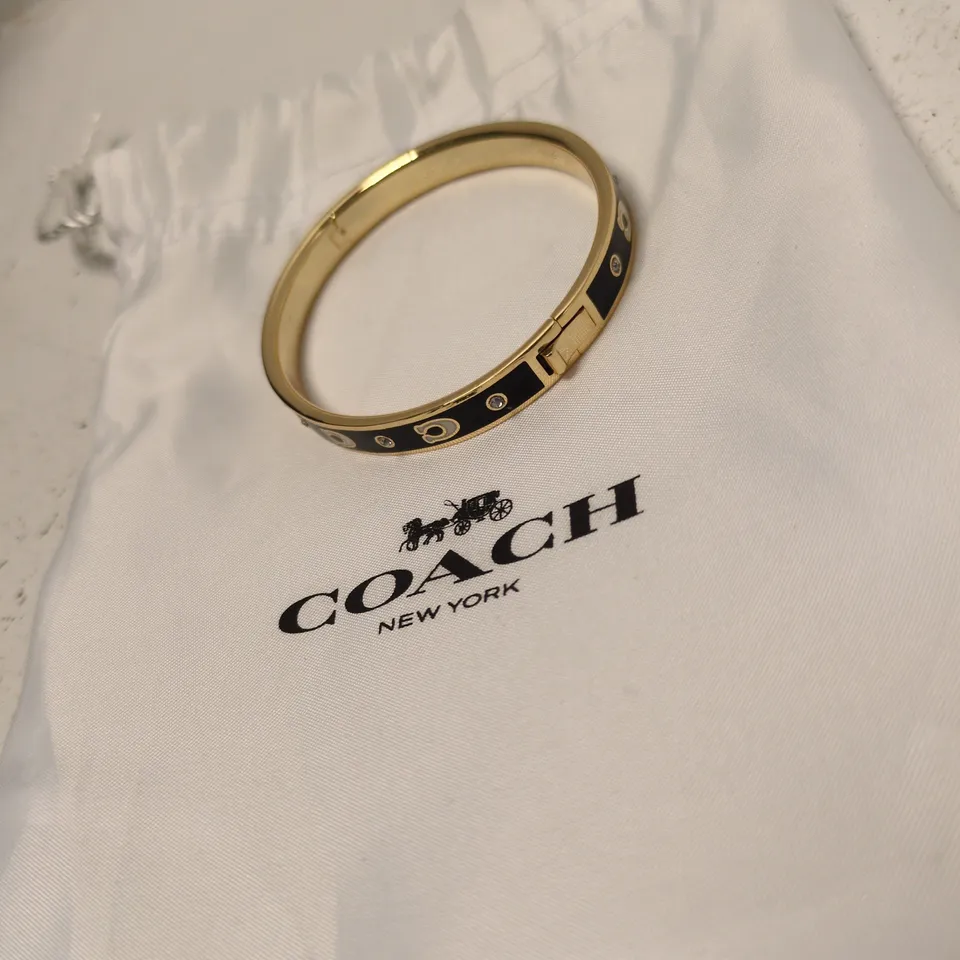 COACH GOLD-TONE BRACELET WITH BLACK ENAMEL AND CRYSTAL ACCENTS