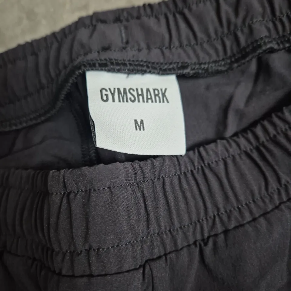 GYMSHARK MEN'S TRACK PANTS – BLACK WITH WHITE SIDE STRIPES, SIZE M
