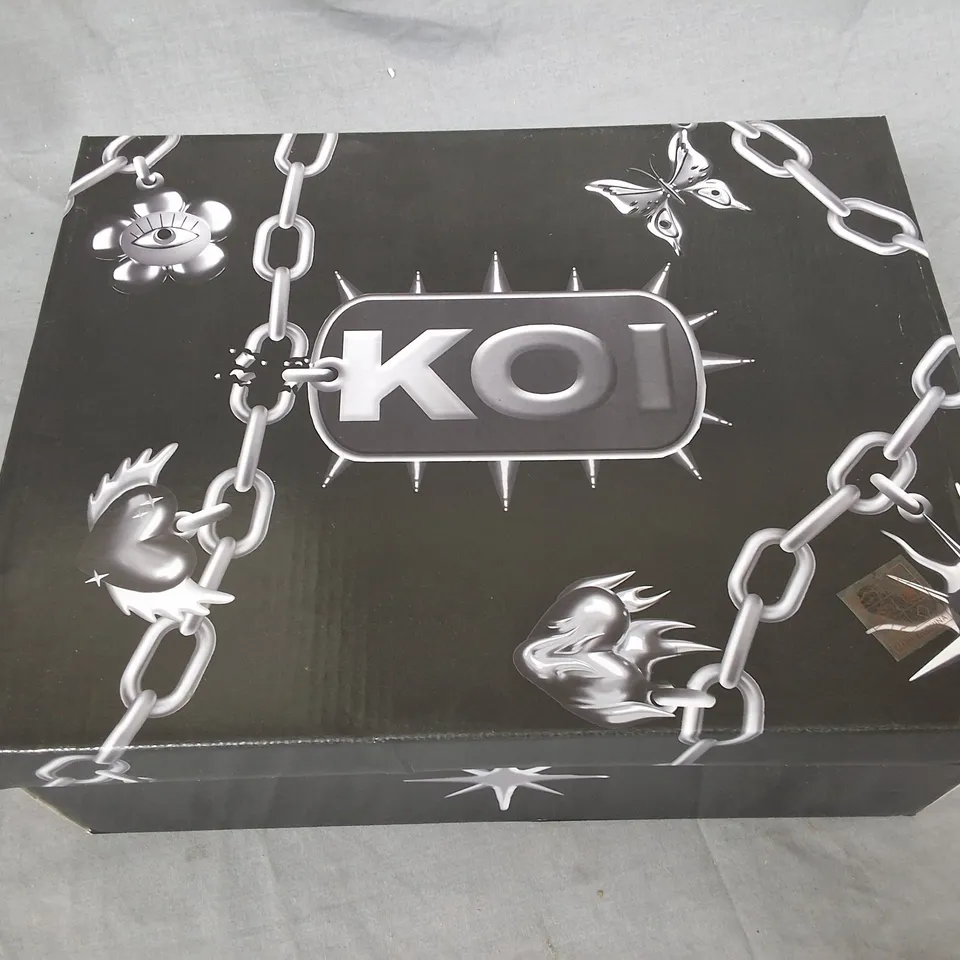 BOXED PAIR OF KOI BANE OF EXILE TRAINERS - UK 6