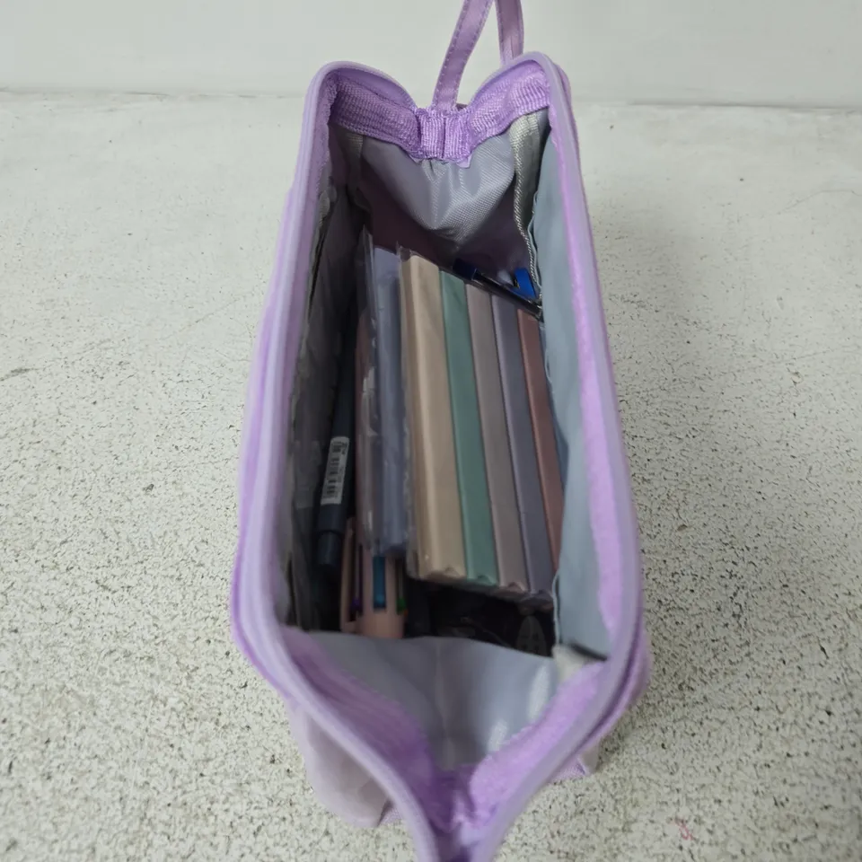 Purple pencil case with multiple zip compartments and pens etc inside