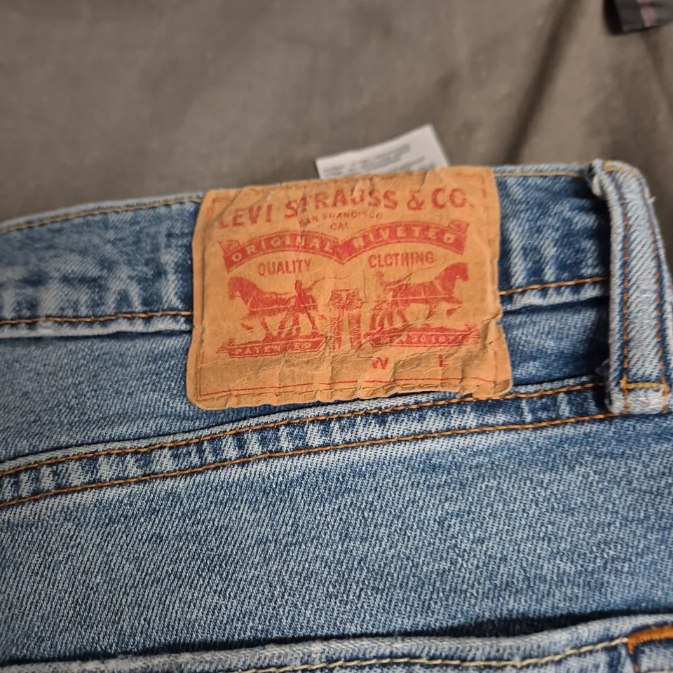 LEVI'S JEANS – BLUE DENIM WITH RED BACK PATCH SIZE UNSPECIFIED .