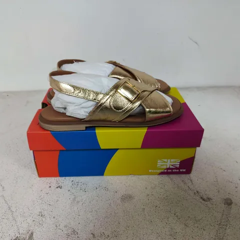 BOXED PAIR OF ADESSO ZIVA SANDAKS IN GOLD COLOUR - SIZE 6