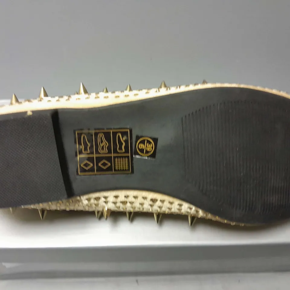 APPROXIMATELY 13 CASANDRA SPIKED SLIPONS IN CHAMPAGNE SATIN IN VARIOUS SIZES