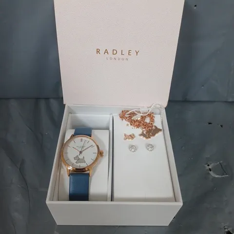 BOXED RADLEY BLUE LEATHER STRAP WATCH WITH 18CT RGP STUD EARRINGS AND CHARM BRACELET