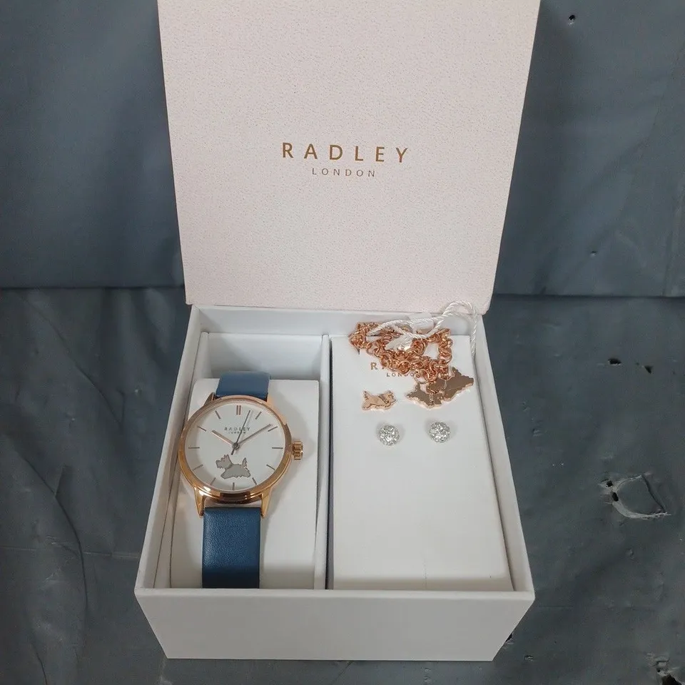 BOXED RADLEY BLUE LEATHER STRAP WATCH WITH 18CT RGP STUD EARRINGS AND CHARM BRACELET