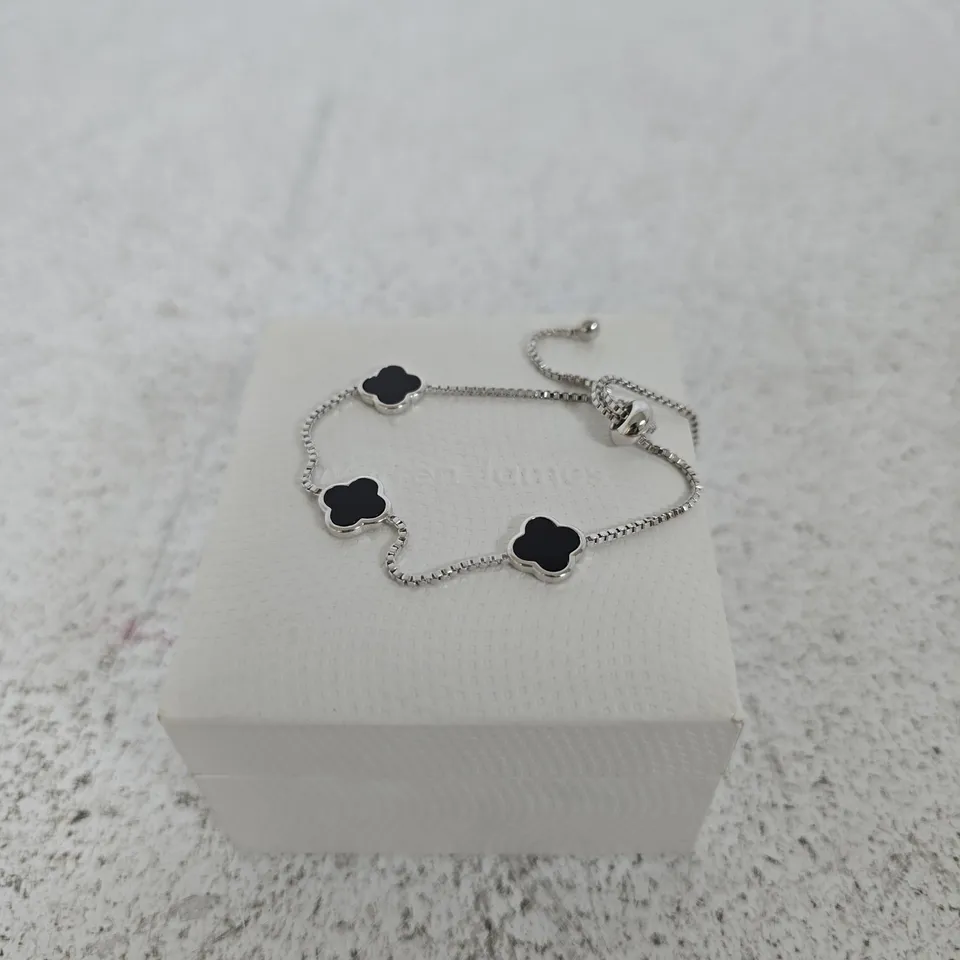 WARREN JAMES SILVER-TONE BRACELET WITH BLACK ENAMEL FOUR-LEAF CLOVER CHARMS