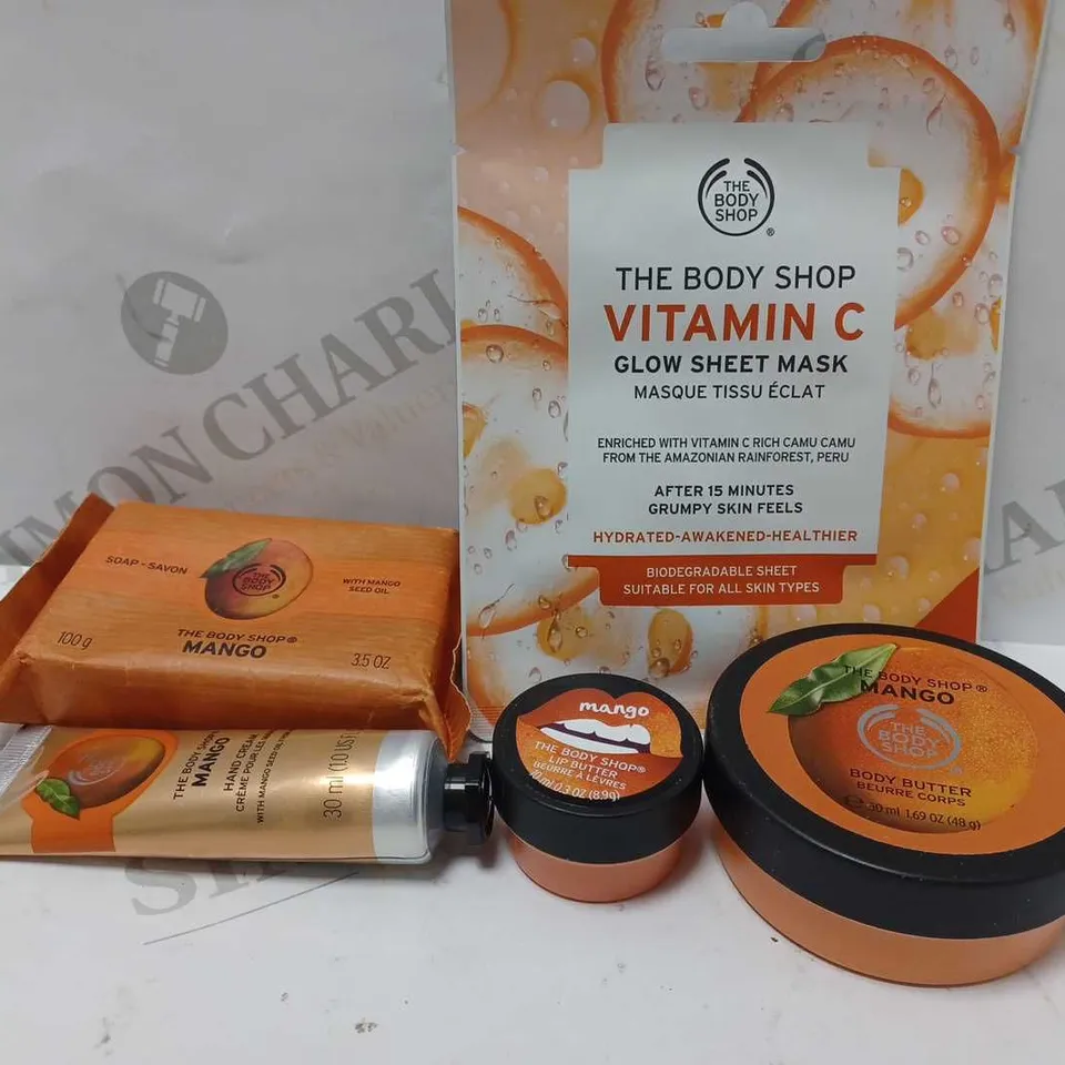 LOT OF 5 THE BODY SHOP MANGO PRODUCTS TO INCLUDE GLOW SHEET MASK, BODY BUTTER, LIP BUTTER, HAND CREAM, SOAP