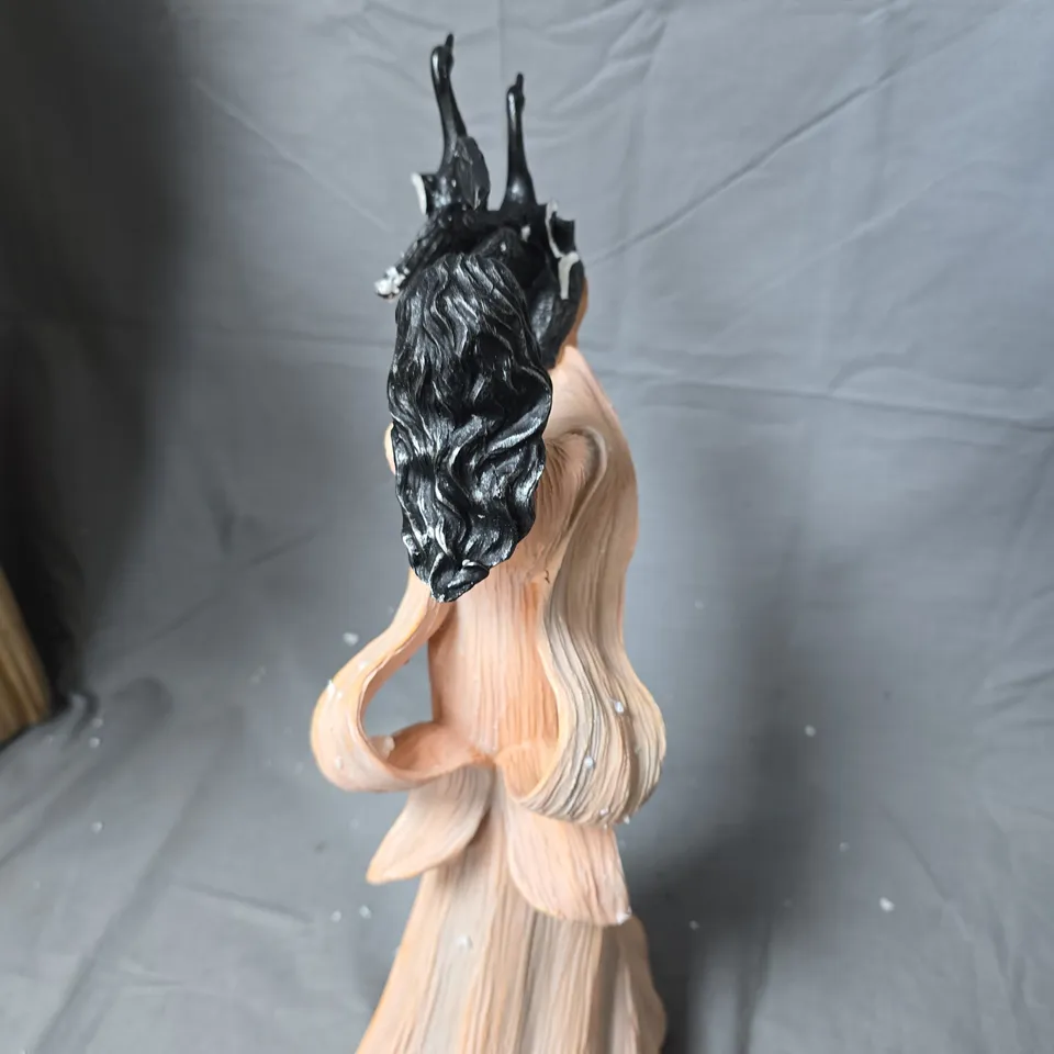 SCULPTURE OF A WOMAN IN PEACH GOWN WITH BLACK BIRD FORMS ON TOP-BROKEN WING 