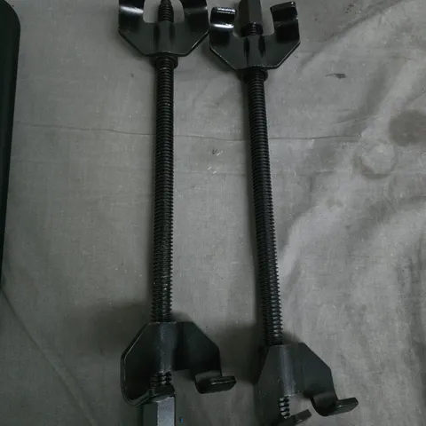 PAIR OF BLACK ADJUSTABLE SCREW CLAMPS WITH LONG THREADED RODS FOR REMOVING SPRINGS AND COILS 