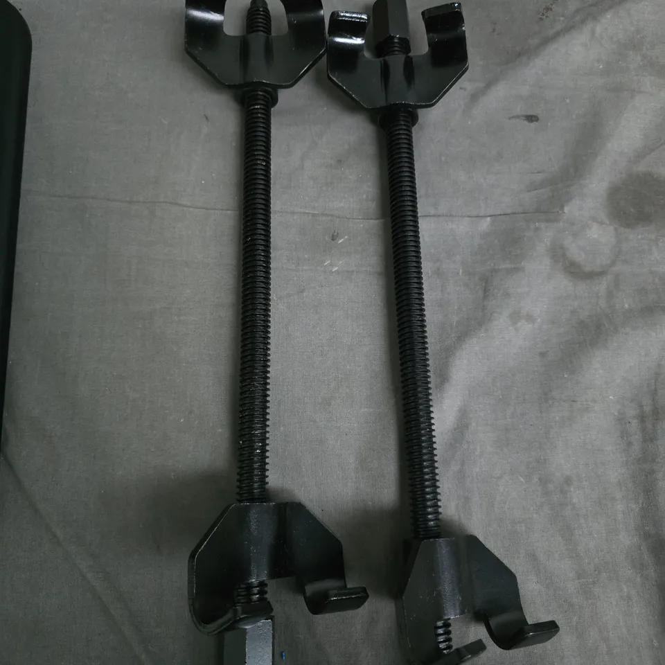 PAIR OF BLACK ADJUSTABLE SCREW CLAMPS WITH LONG THREADED RODS FOR REMOVING SPRINGS AND COILS 