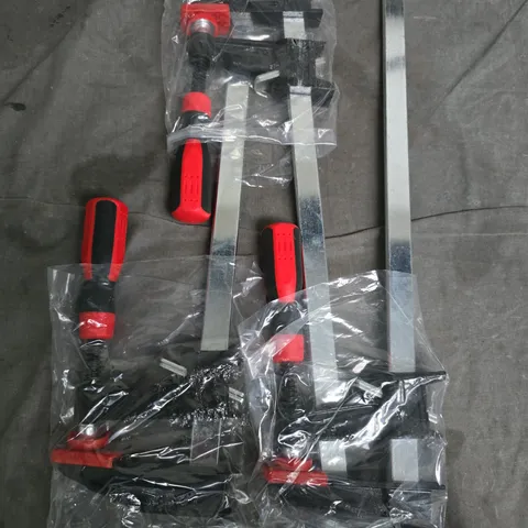 Metal Bar Clamps with Red Handles – Likely Woodworking Clamps 