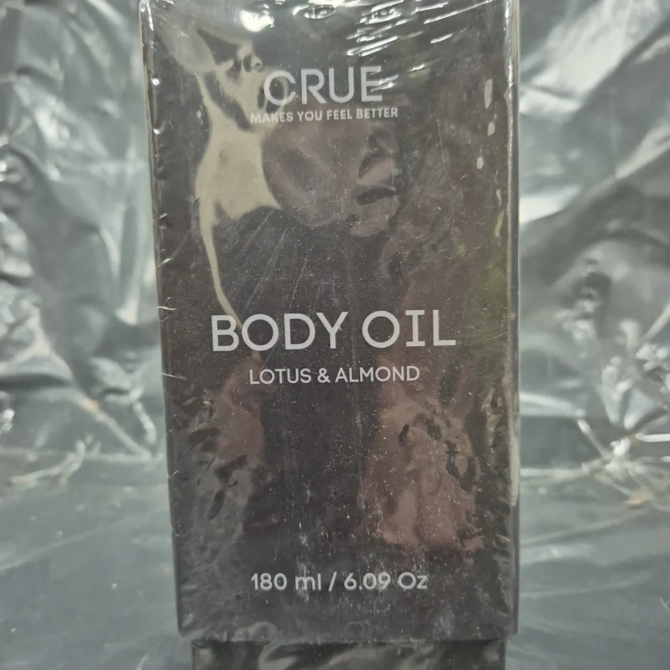 BOX OF APPROXIMATELY 16 SEALED CRUE LOTUS & ALMOND BODY OIL (180ML)